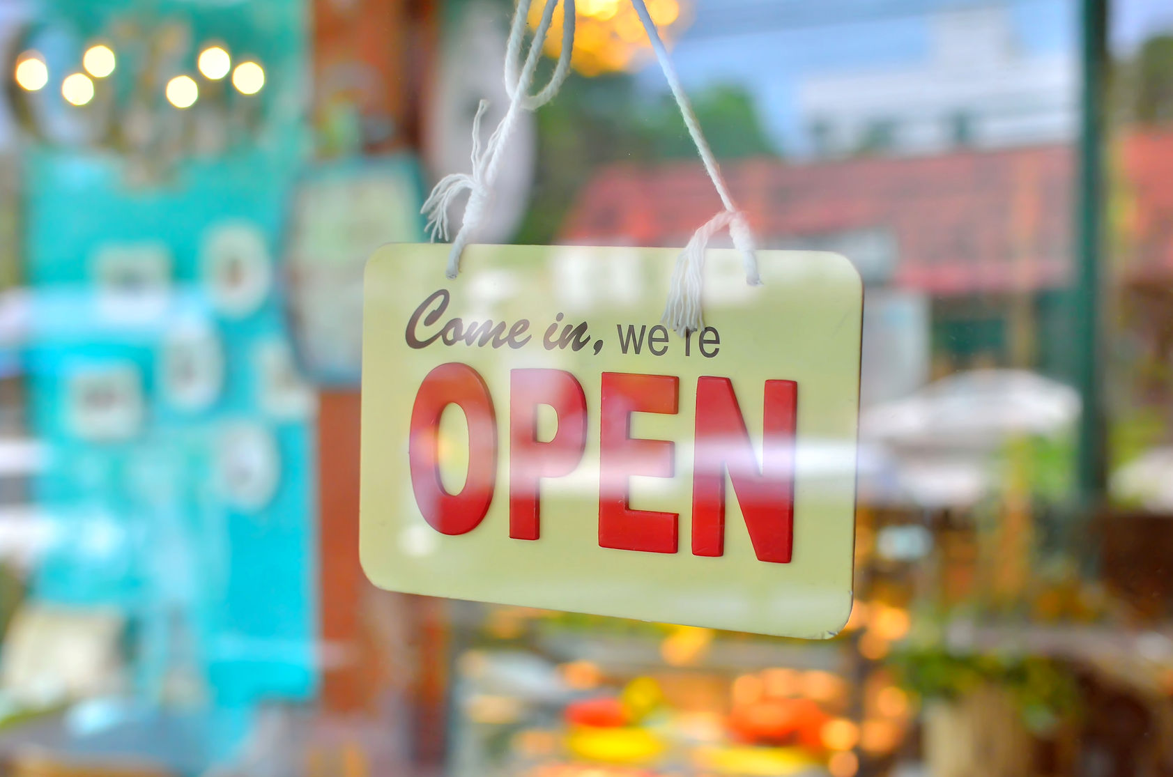 open sign broad through the glass of window at coffee shop